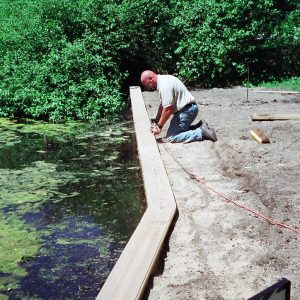 Mucky canal seawall with 10' tall PVC sheeting.