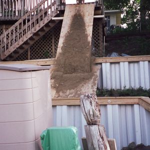 Building and backfilling a two terraced Grey PVC retention wall by hand and wheel barrow! Houses were 6-8' apart on this lake and too steep for heavy equipment!