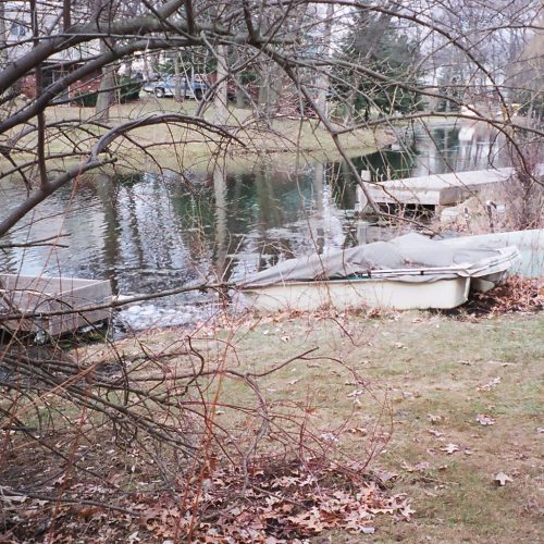 Mucky canal seawall with 10' tall PVC sheeting.