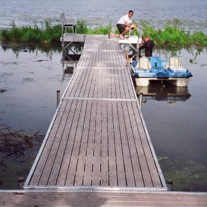 220' Metal craft dock that makes a custom Right turn with two 8X8 platforms. Accessories included stairs, bumpers cleats and custom pads for the deep muck present on this installation.