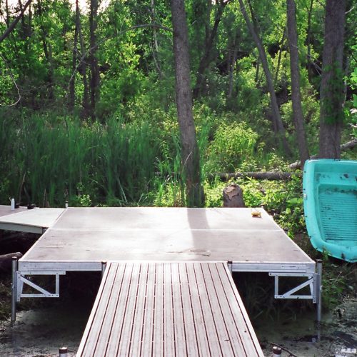 220' Metal craft dock that makes a custom Right turn with two 8X8 platforms. Accessories included stairs, bumpers cleats and custom pads for the deep muck present on this installation.