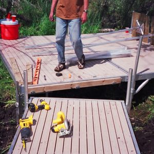 220' Metal craft dock that makes a custom Right turn with two 8X8 platforms. Accessories included stairs, bumpers cleats and custom pads for the deep muck present on this installation.