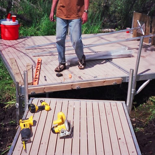 220' Metal craft dock that makes a custom Right turn with two 8X8 platforms. Accessories included stairs, bumpers cleats and custom pads for the deep muck present on this installation.